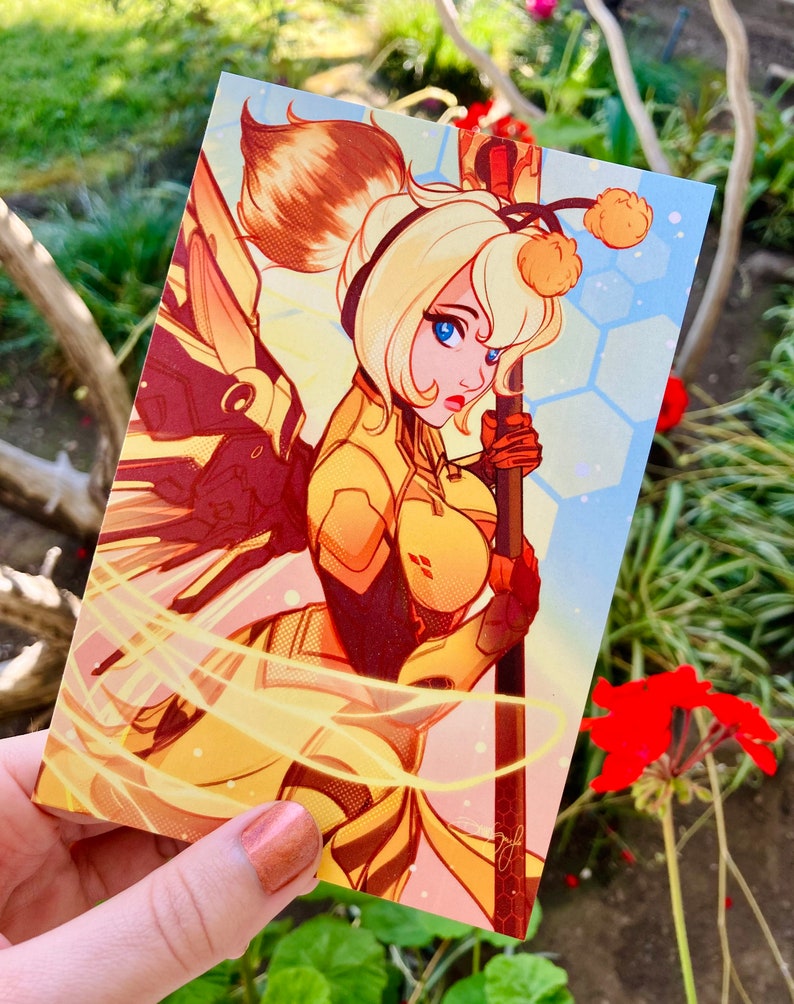 May include: A yellow and orange illustration of a character with a bee-themed costume and wings. The character is holding a staff with a yellow pom-pom on top. The background is a light blue with a honeycomb pattern.