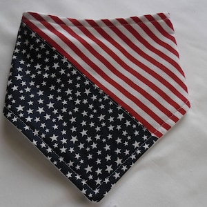 May include: A red, white, and blue bandana with a diagonal stripe pattern on one side and a star pattern on the other side.
