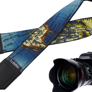 May include: A blue and yellow camera strap with a world map design. The strap has black leather ends and the text "InTePro" is printed on one end. A black DSLR camera with a large lens is also pictured.
