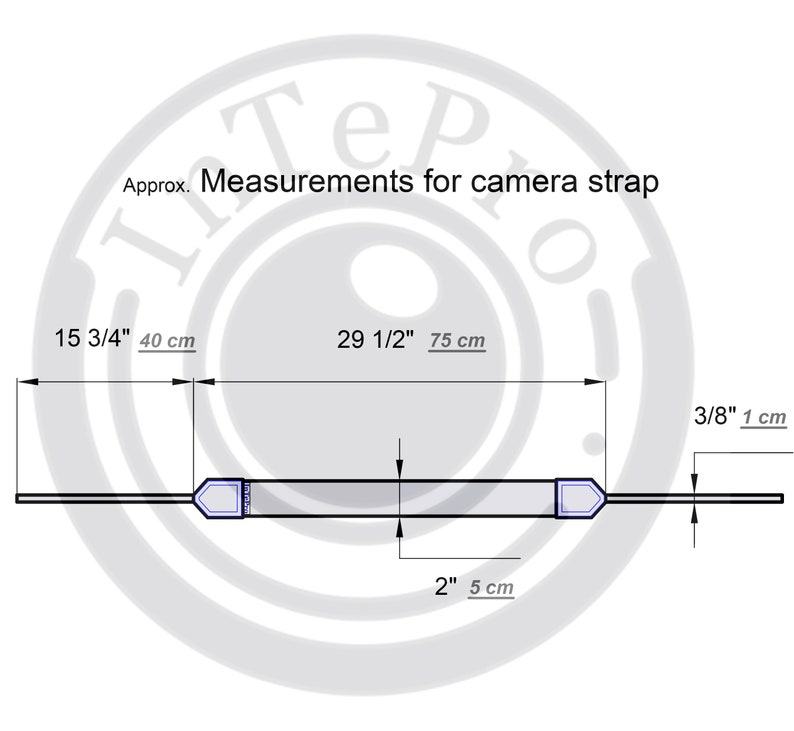 May include: Diagram showing the measurements of a camera strap. The strap is 15 3/4 inches (40 cm) long and 2 inches (5 cm) wide. The strap has two adjustable ends, each measuring 3/8 inch (1 cm) wide.