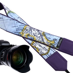 May include: A purple camera strap with a world map design. The strap features the text "InTePro" and a map of North America, Australia, and parts of Asia.