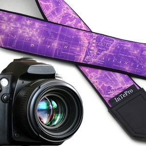 May include: Purple camera strap with a vintage world map design. The strap has a black leather pad with the text "InTePro" printed in white.