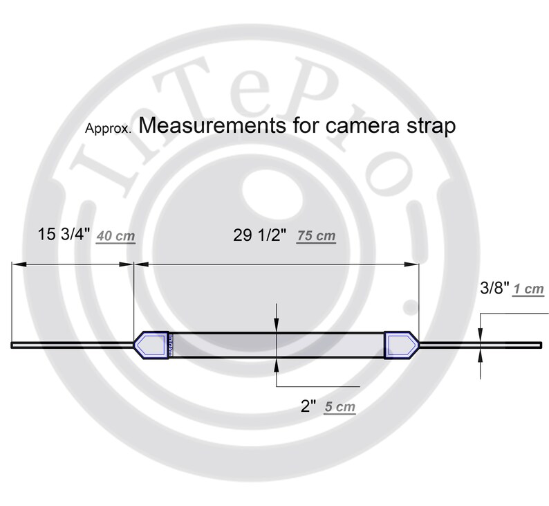 May include: Diagram showing the measurements of a camera strap. The strap is 15 3/4 inches (40 cm) long and 2 inches (5 cm) wide. The strap has two adjustable ends, each measuring 3/8 inch (1 cm) wide.