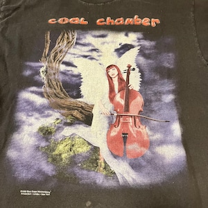 May include: A black t-shirt with a graphic of a woman in a white dress playing a cello. The woman has red hair and is surrounded by clouds. The text "coal chamber" is printed in orange at the top of the shirt.