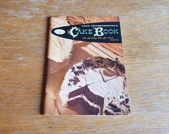 May include: A vintage Good Housekeeping's Cake Book with a photo of a chocolate cake with white frosting and chocolate shavings on the cover. The book is priced at 39 cents.