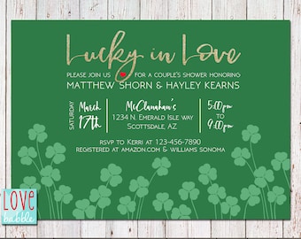 May include: Green invitation with gold glitter text that reads "Lucky in Love". The invitation is for a couple's shower honoring Matthew Shorn and Hayley Kearns. The event will be held on Saturday, March 17th from 5:00pm to 9:00pm at McClanahan's, 1234 N. Emerald Isle Way, Scottsdale, AZ. RSVP to Kerri at 123-456-7890. The couple is registered at Amazon.com and Williams Sonoma.