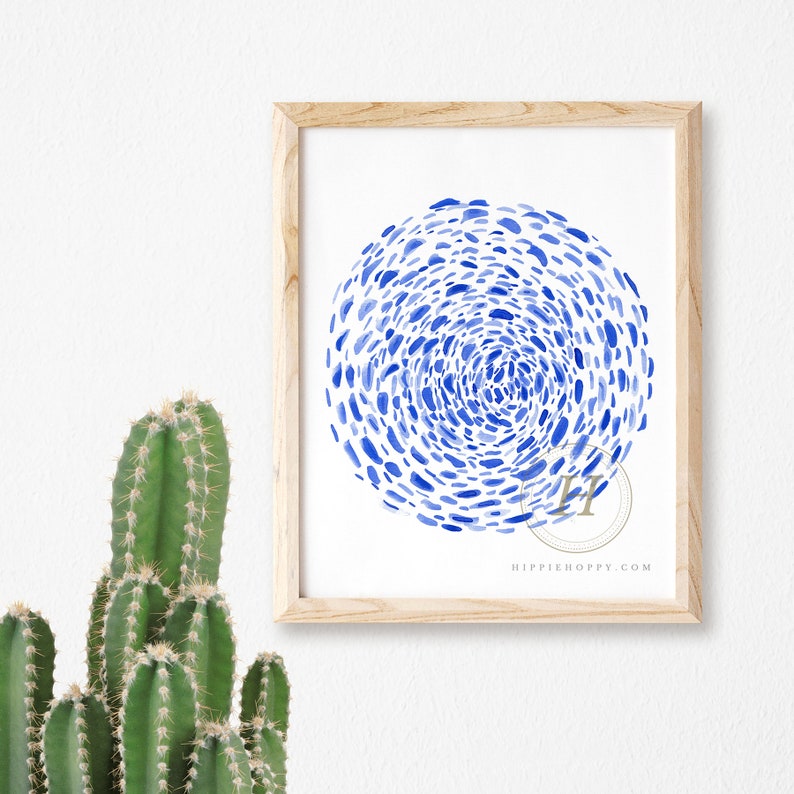 May include: A framed print with a blue watercolor design of a circle made up of small blue dots. The print has the text "HIPPIHOPPY.COM" at the bottom.