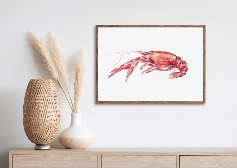 May include: Watercolor painting of a red crayfish on a white background. The crayfish is depicted in a side view, with its claws extended and its tail curled.
