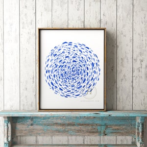 May include: A framed watercolor painting of a blue abstract circle design on a white background. The circle is made up of many small blue dots that are arranged in a swirling pattern.