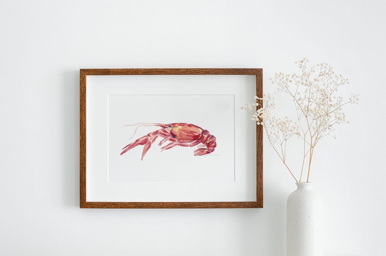 May include: A framed watercolor painting of a red crayfish on a white background. The frame is brown wood.