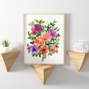 May include: A framed watercolor painting of a bouquet of pink, purple, and orange flowers with green leaves. The painting is on a white background and is framed in a light wood frame.