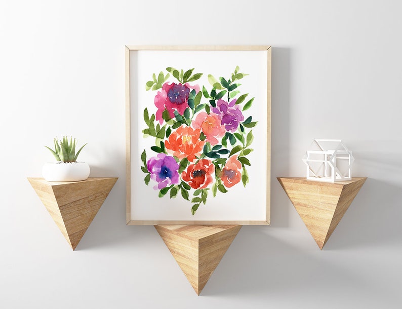 May include: A framed watercolor painting of a bouquet of pink, purple, and orange flowers with green leaves. The painting is on a white background and is framed in a light wood frame.