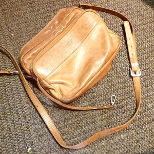Vintage Kenneth Cole New York soft leather 3 zippers, detachable & adjustable strap, has the character of a well loved companion. 7x10x5&quot;