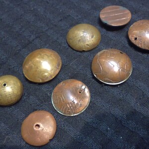 Set of 8 hand made copper and brass beads, varying size and shape, from 19x11mm to 10x24mm. both sides shown.