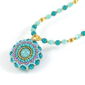 May include: A turquoise and light blue beaded necklace with a gold chain and a turquoise and pink beaded pendant.