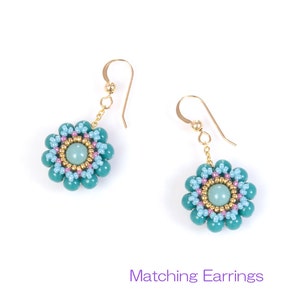May include: A pair of gold dangle earrings with turquoise and light blue flower-shaped bead clusters. The center of each flower has a light green gemstone.