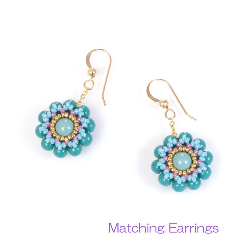 May include: A pair of gold dangle earrings with turquoise and light blue flower-shaped bead clusters. The center of each flower has a light green gemstone.