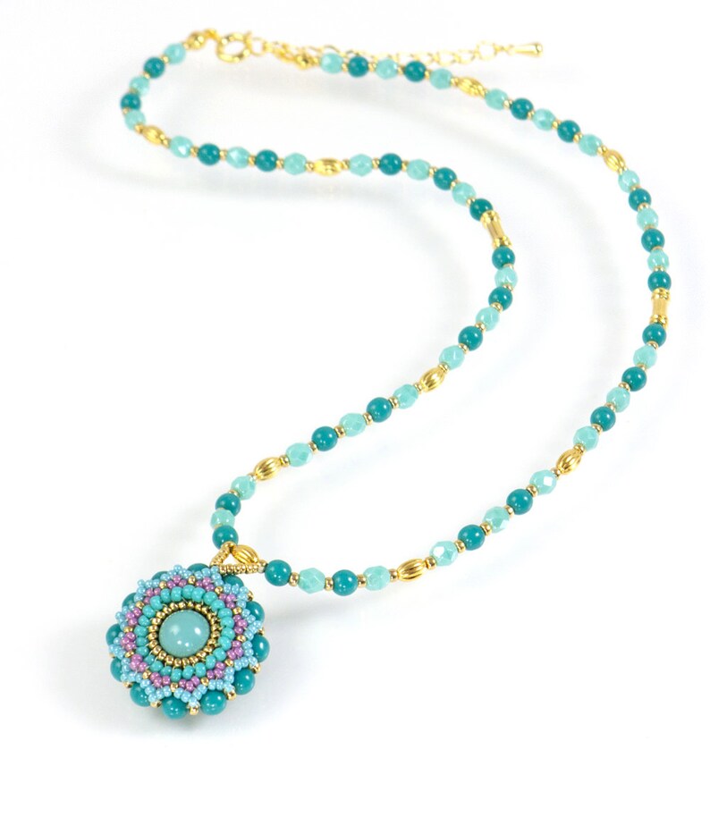 May include: A turquoise and light blue beaded necklace with a gold chain and a turquoise and pink beaded pendant.
