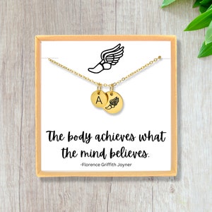 May include: Gold necklace with a charm of a running shoe and a letter A. The necklace comes in a box with the quote "The body achieves what the mind believes." -Florence Griffith Joyner
