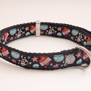 Peut inclure: Collier de chien noir avec un motif coloré de cœurs, de crânes, d'étoiles et le mot "Forever".