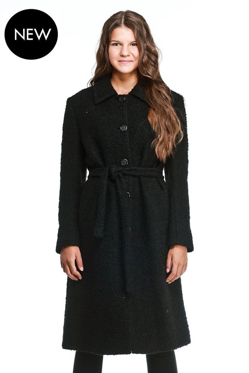 May include: A black long-sleeved coat with a belt and button fastening. The coat has a textured fabric and a classic style.
