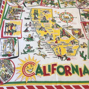May include: White tablecloth with a vibrant map of California, showcasing landmarks and attractions. The word "CALIFORNIA" is in large, red and green letters, with a smiling sun graphic. The tablecloth is likely made of cotton.