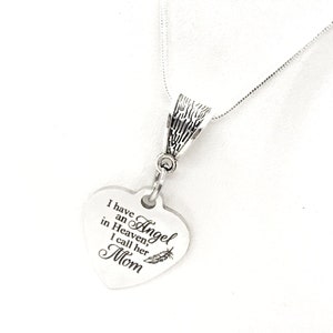 May include: Silver necklace with a heart-shaped pendant that reads "I have an Angel in Heaven, I call her Mom".
