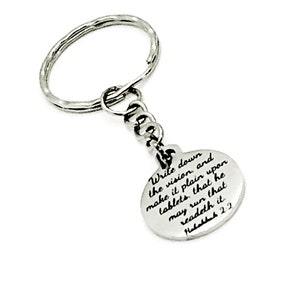 May include: Silver keychain with a round charm that has the text "Write down the vision, and make it plain upon tablets, that he may run that readeth it Habakkuk 2:2" engraved on it.