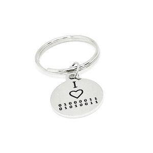 May include: Silver keyring with a round charm that says "I ♥ 01000011 01010011".