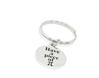 May include: Silver keychain with a round charm that says "Have a piece of Pi".