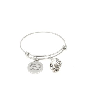May include: Silver expandable bracelet with two charms. One charm is a globe and the other charm is a round disc with the text "You make a world of difference".
