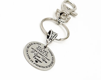 May include: Silver keychain with a round charm that reads "To my niece, I hope you believe in yourself as much as I believe in you. Never forget that I love you forever."