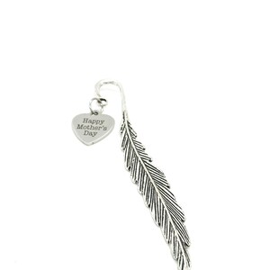 May include: A silver-colored metal bookmark in a feather design. A heart-shaped charm is attached with the text "Happy Mother's Day". The bookmark is against a white background.