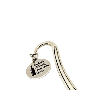 May include: Silver bookmark with a round charm that says "My Book Club only reads wine labels" and a small image of a wine bottle.