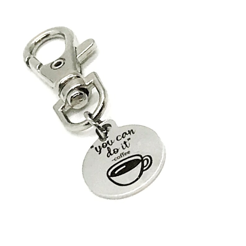May include: Silver keyring with a round charm that says "You can do it - coffee" with a coffee cup graphic.