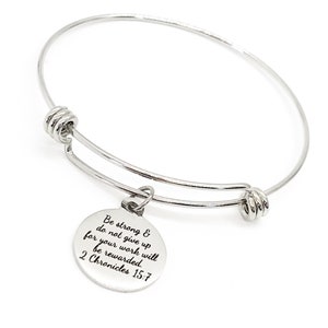 May include: A silver expandable bangle bracelet with a round charm that reads "Be strong & do not give up for your work will be rewarded. 2 Chronicles 15:7".