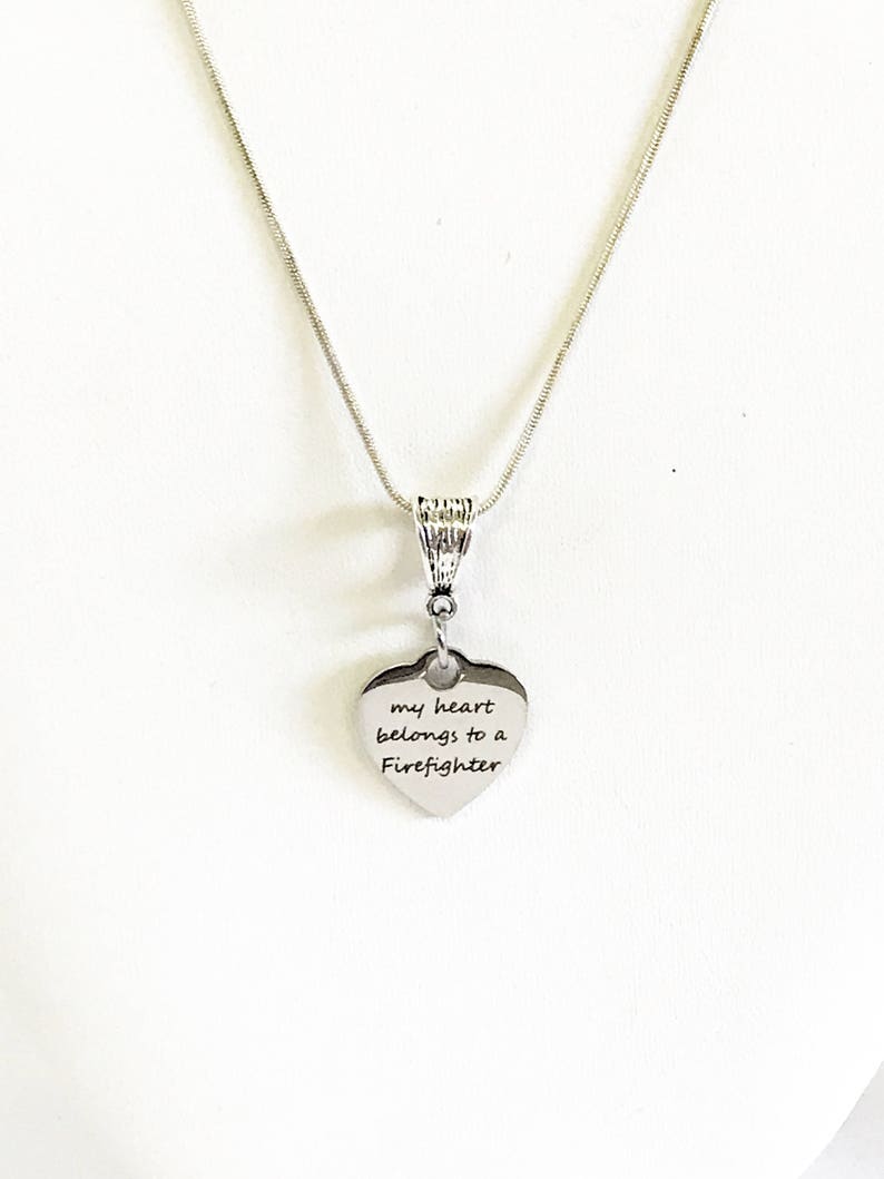 May include: Silver necklace with a heart pendant that says "my heart belongs to a Firefighter".