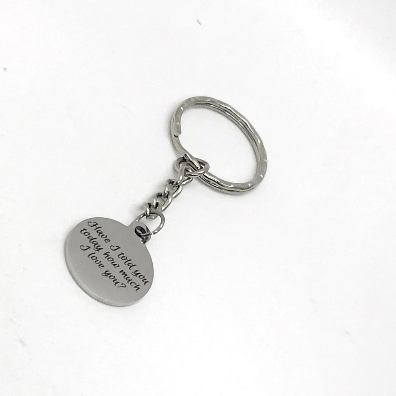 May include: Silver keychain with a round charm that reads "Have I told you today how much I love you?"