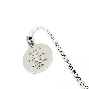 May include: Silver bookmark with a round charm that reads "Always on my Mind Forever in my Heart My beloved Sister".