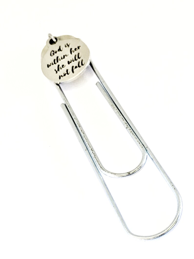 May include: Silver bookmark with a round charm that reads "God is within her she will not fall".