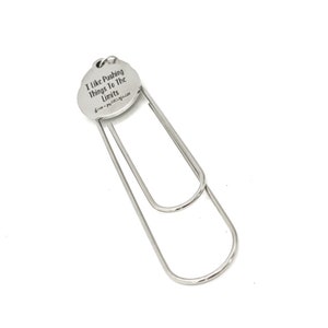 May include: Silver bookmark with a round charm that says "I like pushing things to the limits".