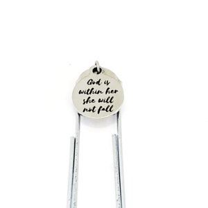 May include: Silver bookmark with a round charm that says "God is within her she will not fall".