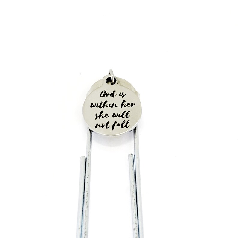 May include: Silver bookmark with a round charm that says "God is within her she will not fall".
