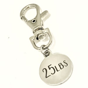 May include: Silver keychain with a round tag that says "25 LBS".