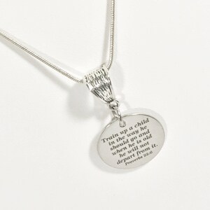 May include: Silver necklace with a round pendant that has the quote "Train up a child in the way he should go and when he is old he will not depart from it. Proverbs 22:6" engraved on it.
