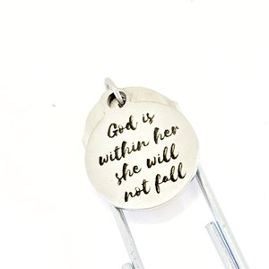 May include: Silver bookmark with a round charm that reads "God is within her she will not fall".