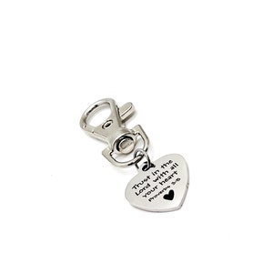 May include: Silver keychain with a heart-shaped charm that reads "Trust in the Lord with all your heart Proverbs 3:5".