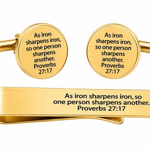 May include: Gold-toned cufflinks and tie clip set. The round cufflinks and rectangular tie clip feature the engraved text "As iron sharpens iron, so one person sharpens another. Proverbs 27:17".