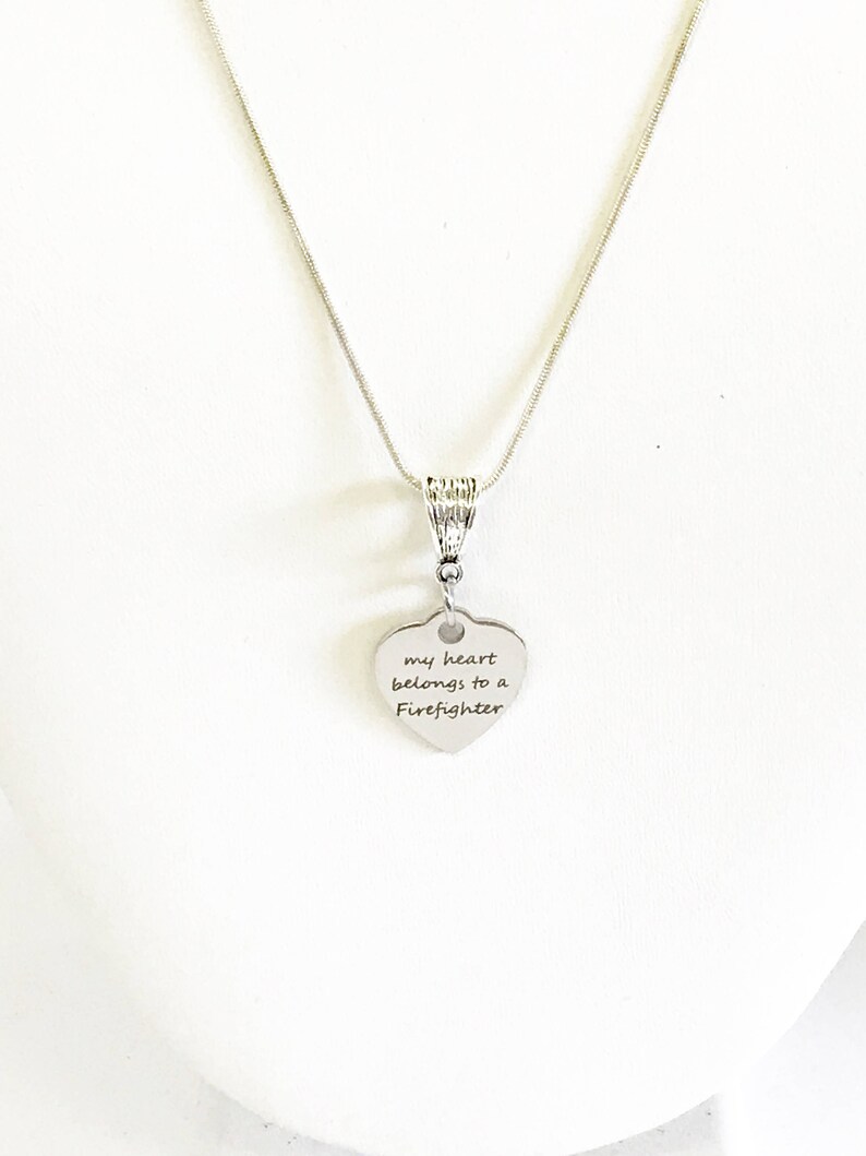 May include: Silver necklace with a heart pendant that says "my heart belongs to a Firefighter".