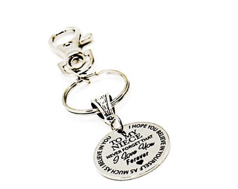 May include: Silver keychain with a round charm that reads "To my niece never forget that I love you forever" with a small heart symbol.